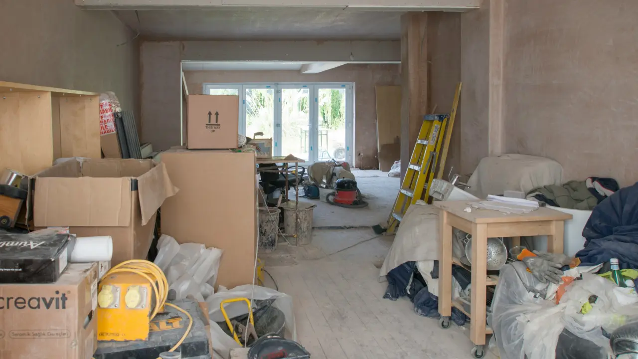 Home renovation worker wearing protective gear to prevent asbestos exposure during old building repairs.