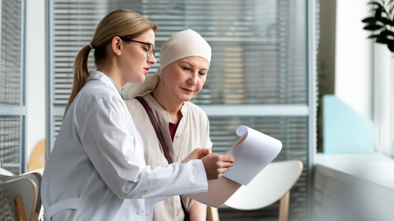Oncologist discussing mesothelioma treatment options with a patient, explaining surgery, chemotherapy, radiation, and immunotherapy.