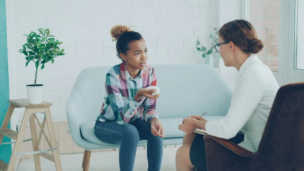 How to reduce anxiety — teenager consulting doctor for anxiety and stress management in a supportive clinical setting