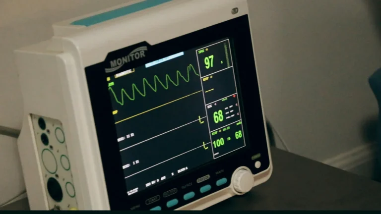 Medical professional using heart rate zones monitor while exercising with digital display showing 5 training zone ranges