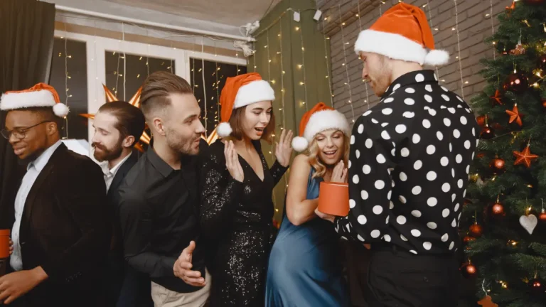 People celebrating at Christmas party with alcohol and festive activities that can trigger holiday heart syndrome