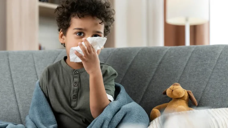 Flu in Kids showing a sick child with fever and runny nose resting at home