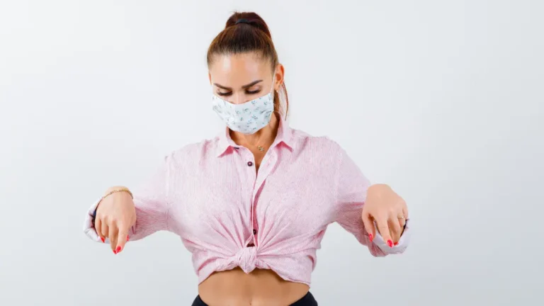 Gastric Sleeve patient pointing to slimmer abdomen after weight loss surgery