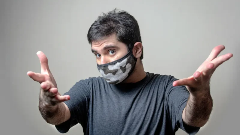 H3N2 Super Flu symptoms - person wearing protective face mask showing flu prevention during 2025 outbreak