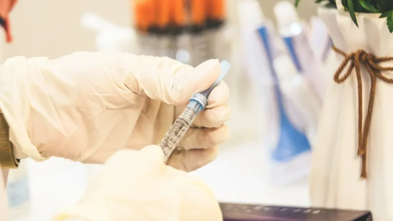 Healthcare professional preparing hepatitis B shot at birth with vaccine syringe for newborn