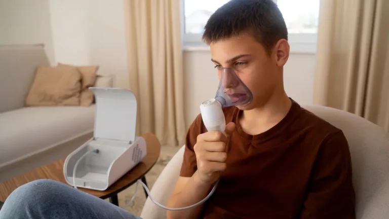 Boy using a nebulizer for breathing support at home – Mepolizumab Severe Asthma Treatment