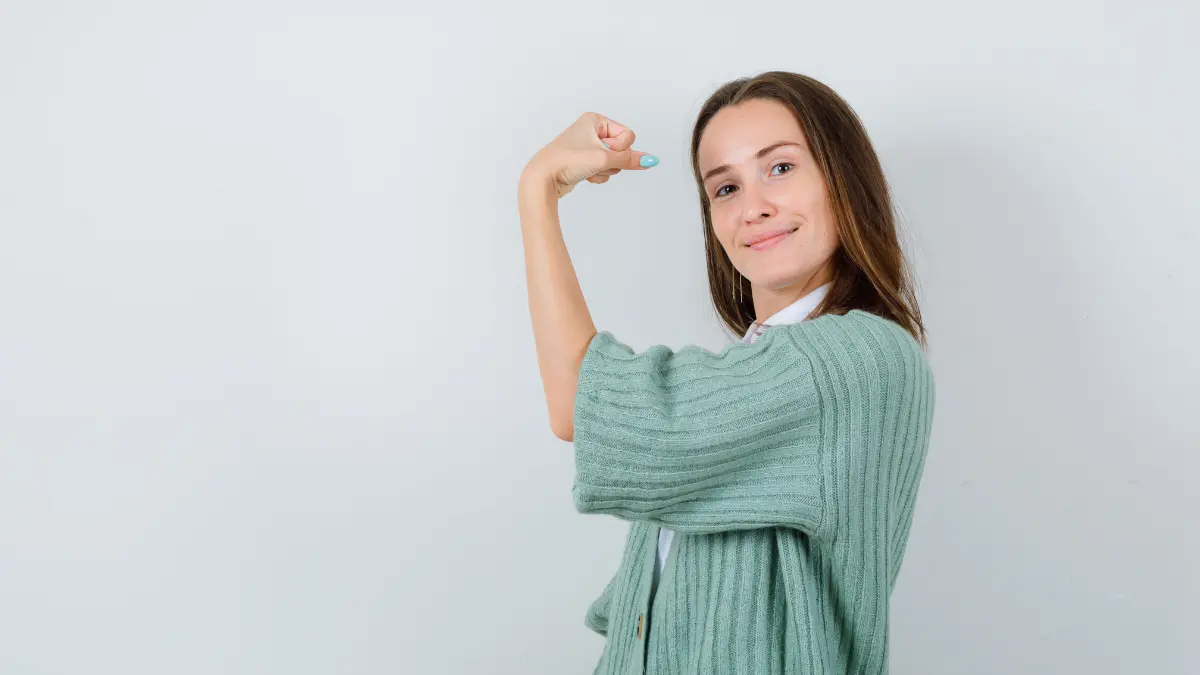 Healthy woman showing arm strength representing immune system recovery and resilience after post-Christmas illness