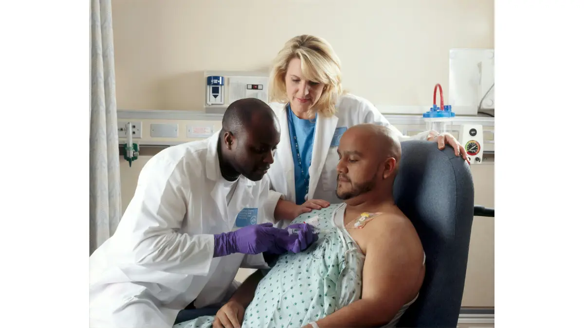 Cancer patient receiving chemotherapy treatment through a chest port at NCI clinical center — representing what patients experience after qualifying and enrolling in a melanoma clinical trial in 2026