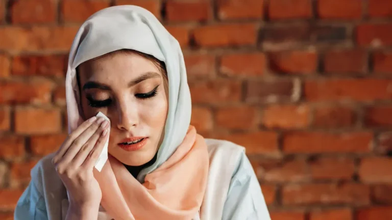 Lung cancer mental health — cancer patient wearing headscarf experiencing anxiety and emotional distress after a lung cancer diagnosis