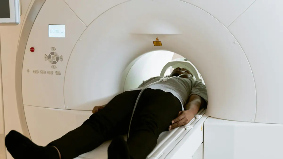 Patient lying inside a low-dose CT scanner during annual LDCT screening — the only imaging approach proven to prevent lung cancer mortality in adults aged 50 to 80 with a 20 pack-year history