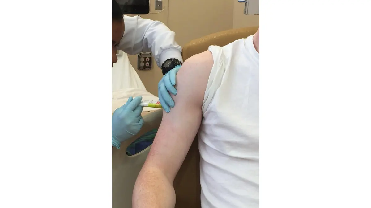 A clinical trial participant receiving an injection during a medical study to improve healthcare outcomes for Black Americans.