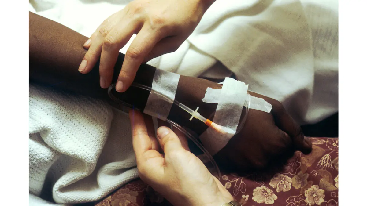 FOLFIRINOX vs. Gemcitabine chemotherapy IV infusion image showing treatment administration through an intravenous line.