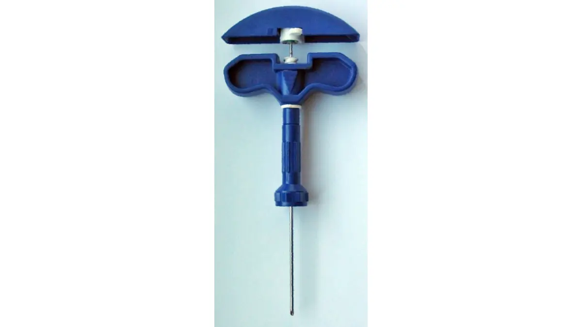 A close-up photograph of a professional bone marrow biopsy needle assembly used during secondary medical screening to evaluate can a CBC detect cancer.