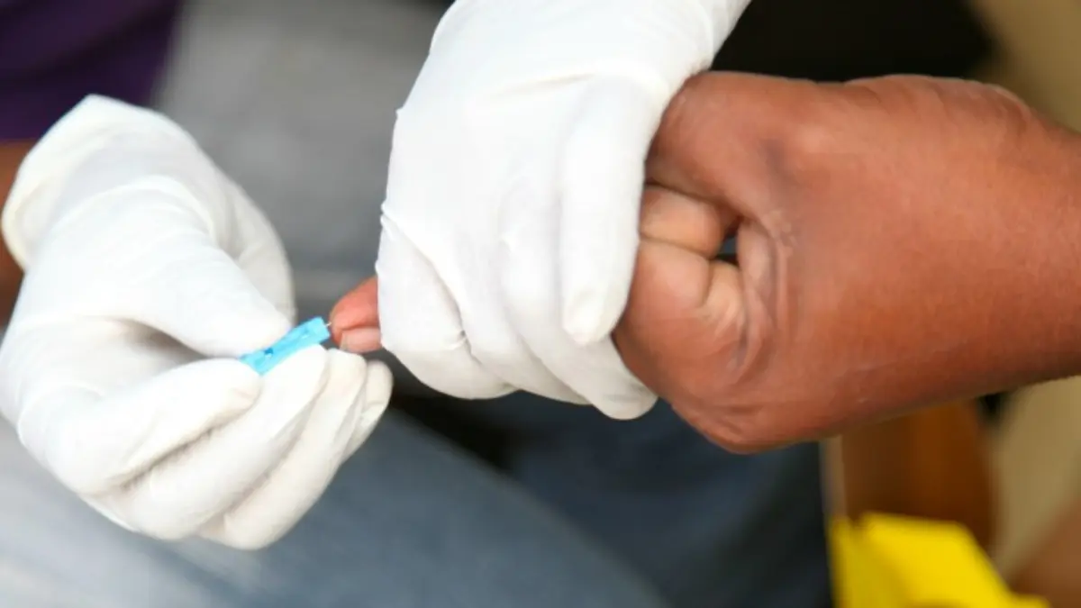 Clinical graphic depicting a medical professional preparing a lancet capillary blood draw for a baseline CBC test.