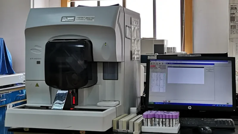 An automated hematology analyzer machine processing laboratory samples to determine how long does a cbc take to run.
