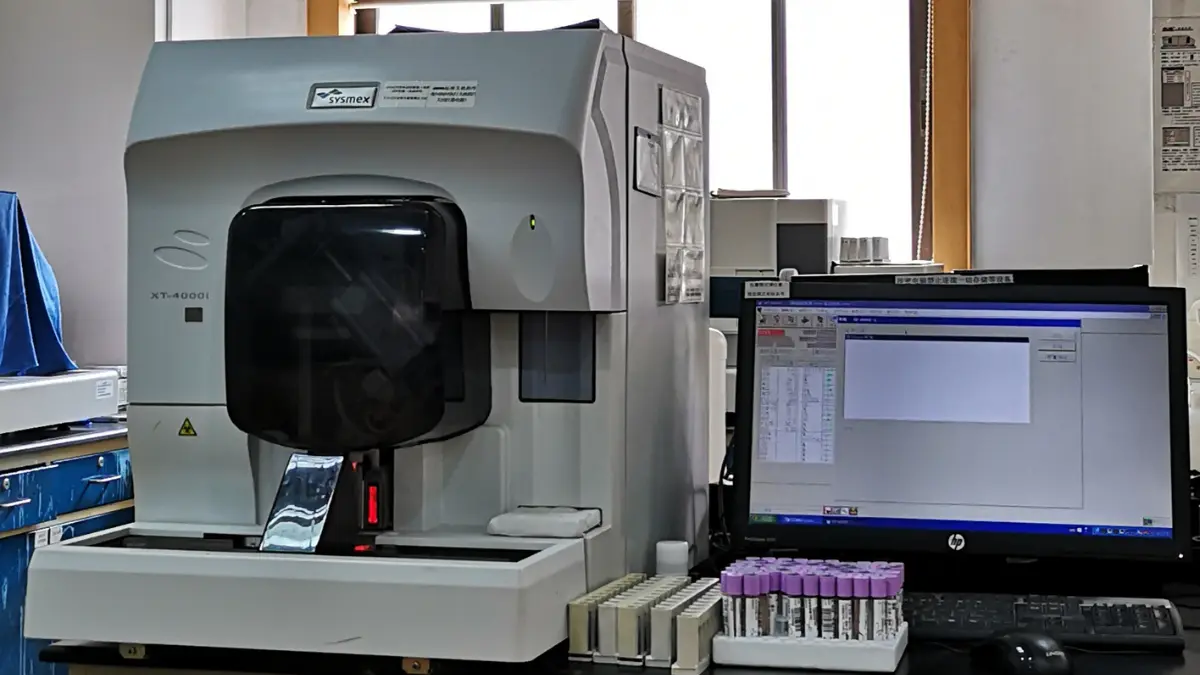 An automated hematology analyzer machine processing laboratory samples to determine how long does a cbc take to run.