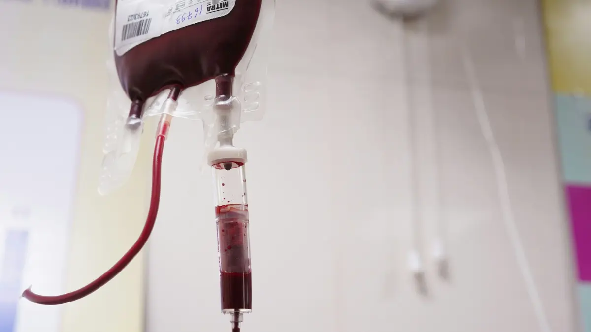 A close-up view of a medical sample collection tube and glass dropper being used to manage specimens while waiting for blood test results.