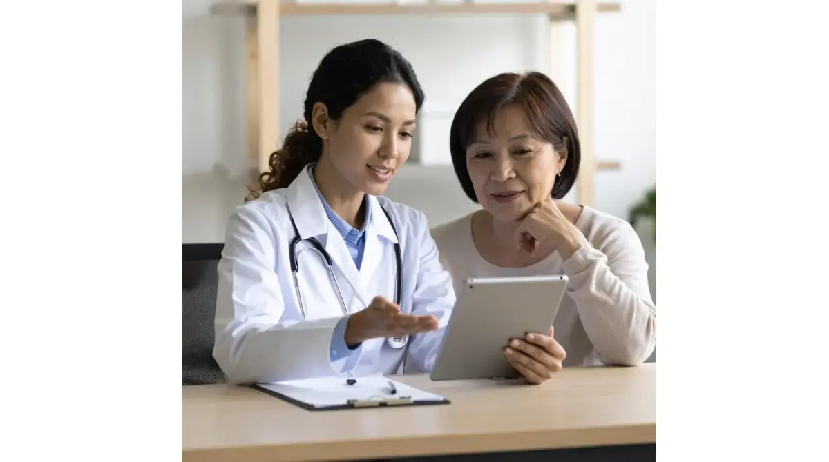 Patient and primary care clinician discussing AST ALT ratio results and MASLD liver enzyme patterns.